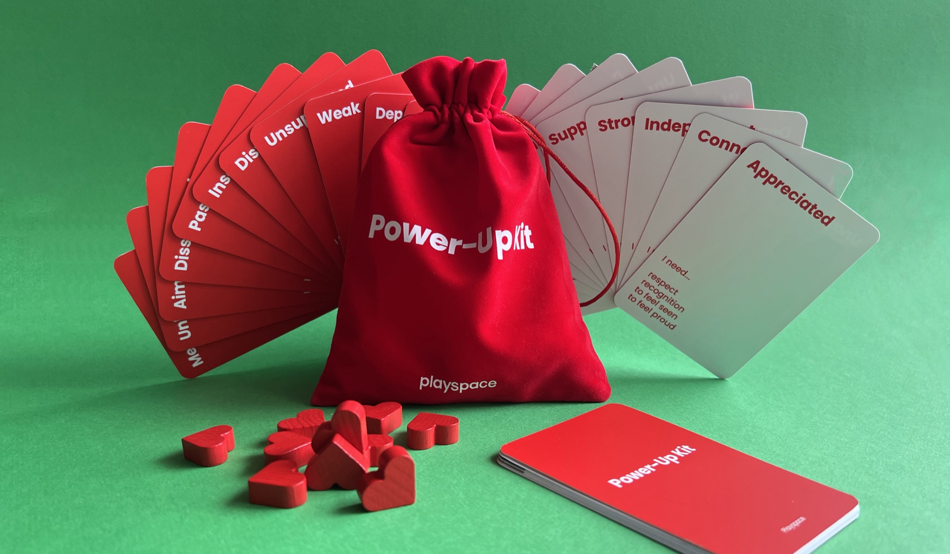 The physical Power-Up Kit with red and white cards, bag and heart tokens